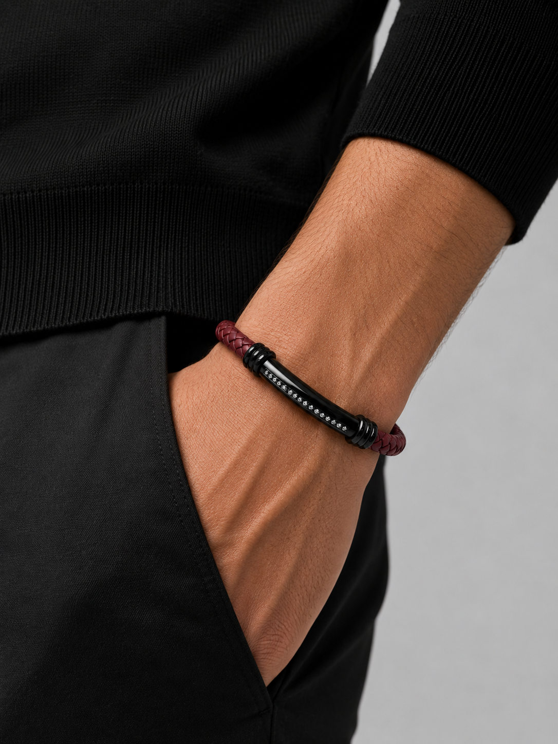 Man wearing the Barutti red braided leather bracelet with ID bar on the wrist