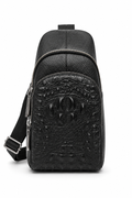 The Bergamo crocodile-embossed leather sling bag in black, worn across the chest