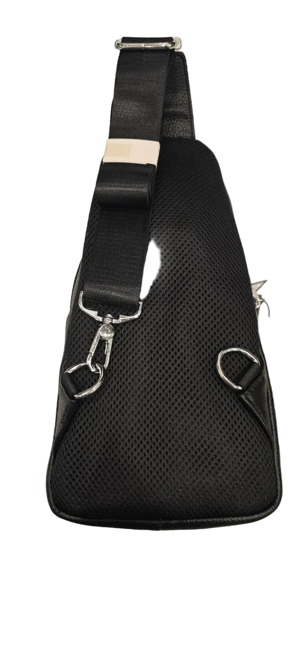 Black sling bag on a textured surface with a visible brand logo.
