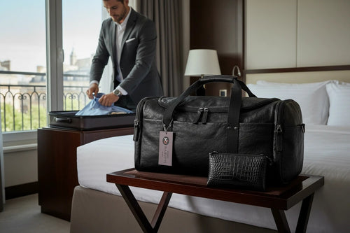 Barutti Bags & Accessories Lucca black full-grain leather weekender duffel bag on a hotel luggage rack.